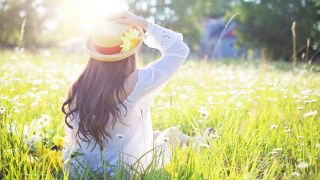 A Woman Sitting in the Flower Feld