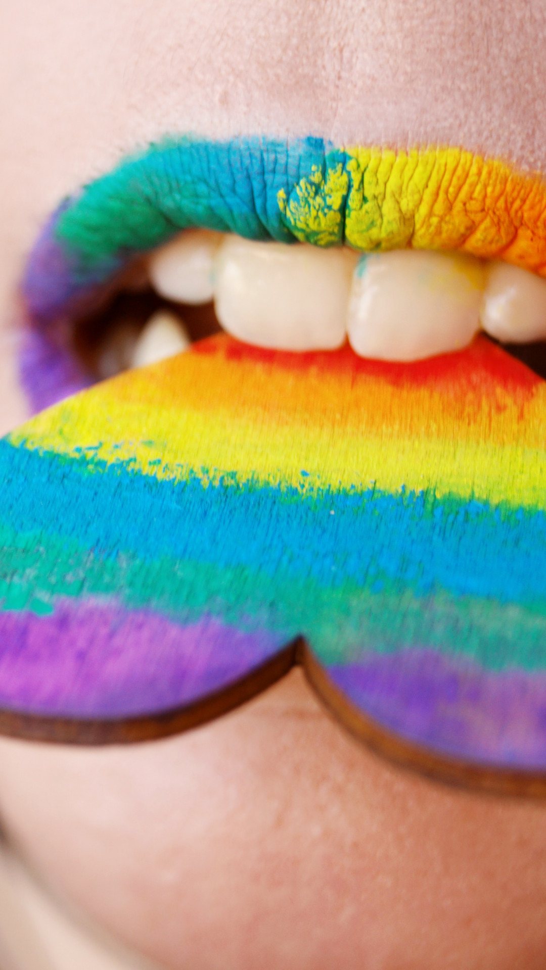 Person Biting Multicolored Heart Decor
