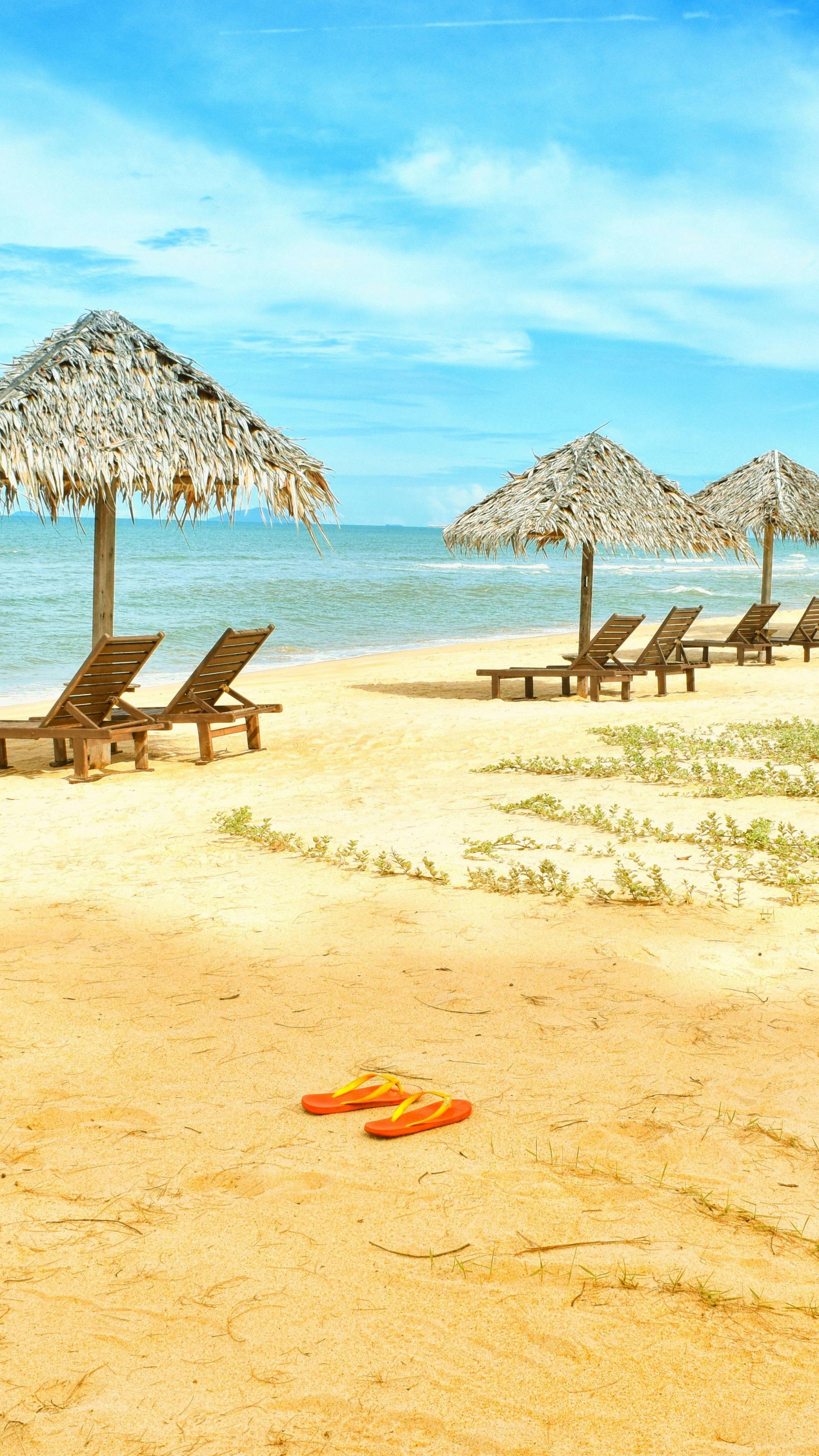 Loungers Under Parasol at Shoreline