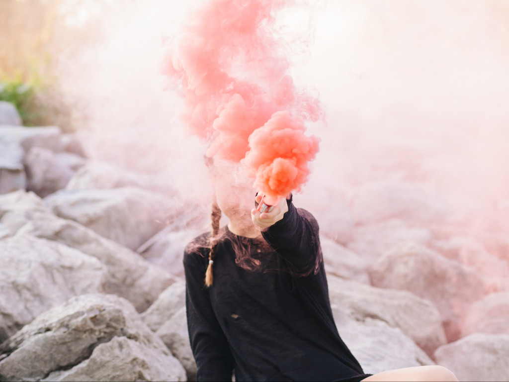 Woman Holding Color Smoke Grenade