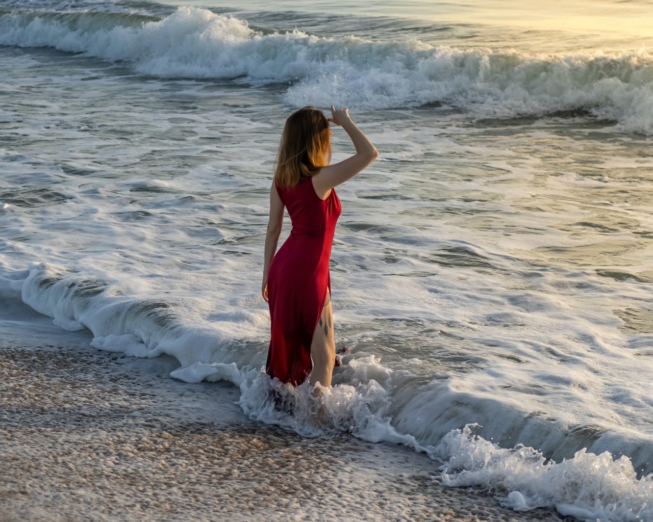 Woman in Red Dress Standing on Beach