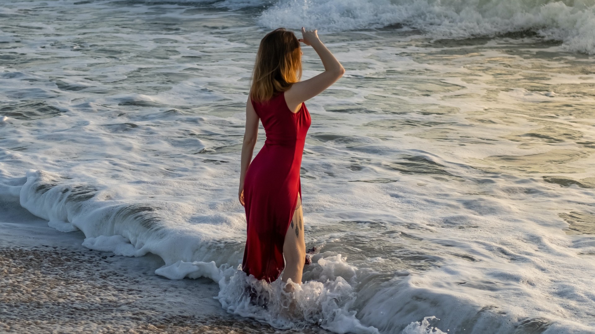 Woman in Red Dress Standing on Beach