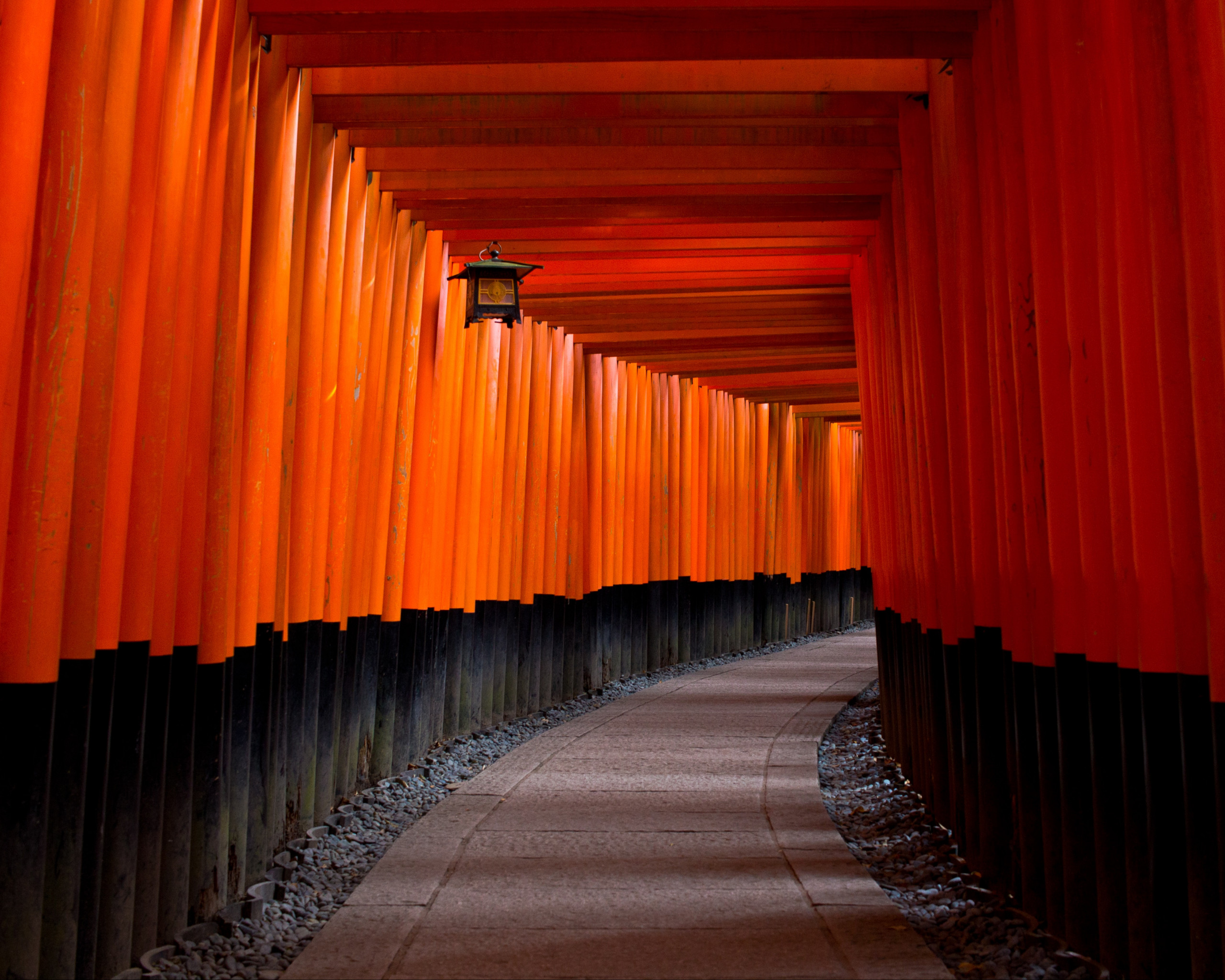 Gray Concrete Pathway Between Red-and-black Pillars