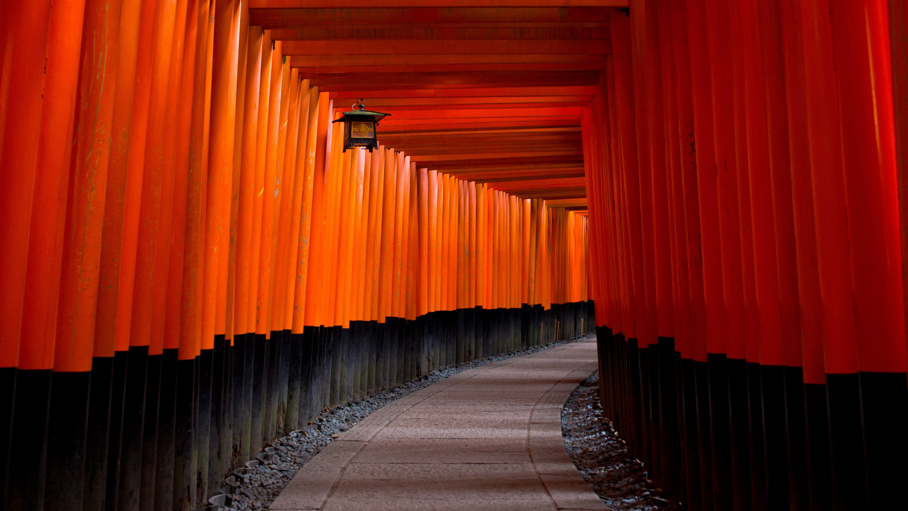 Gray Concrete Pathway Between Red-and-black Pillars