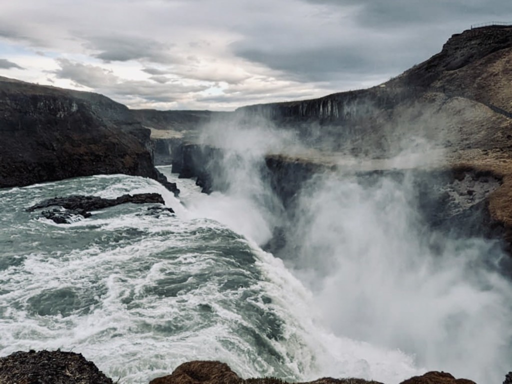 Water Falls on Brown Rocky Mountain