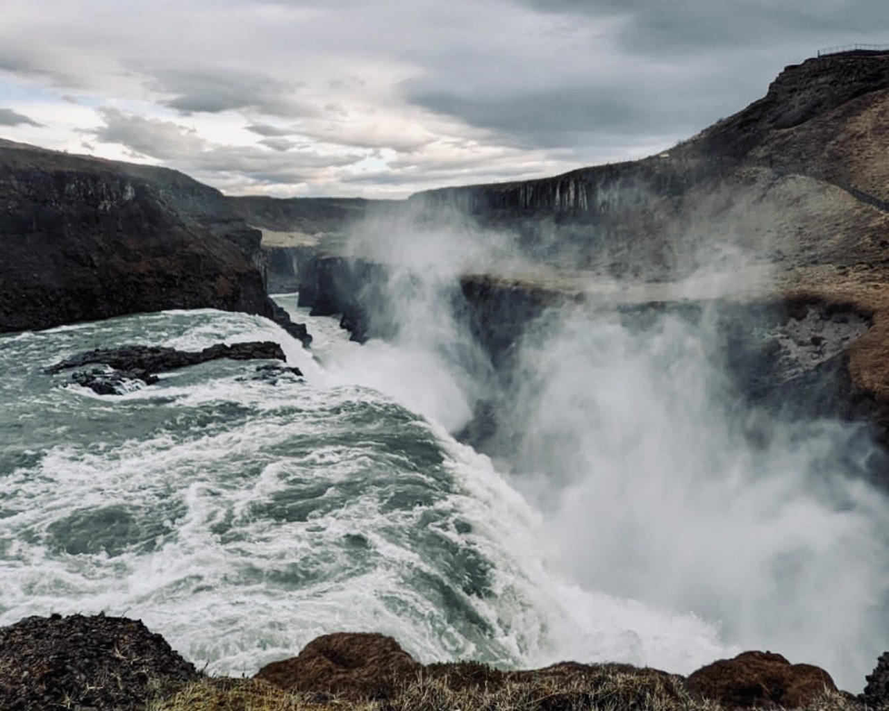 Water Falls on Brown Rocky Mountain