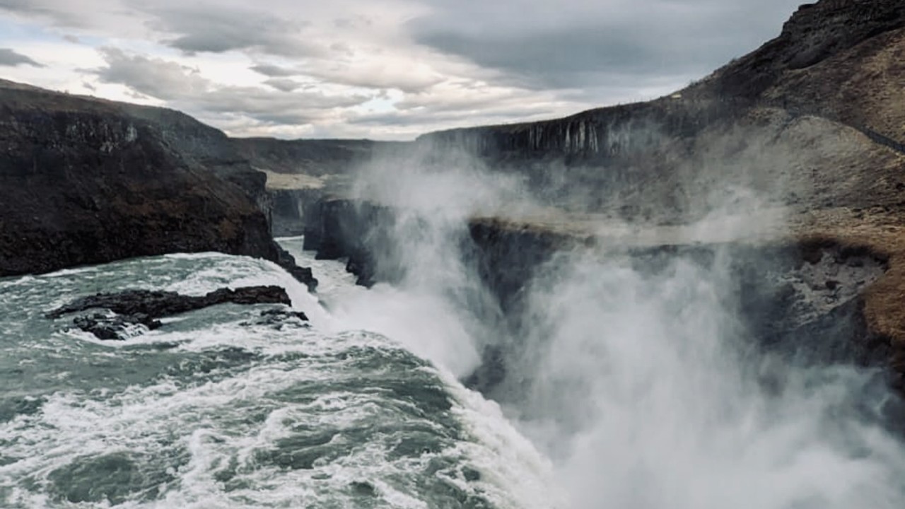 Water Falls on Brown Rocky Mountain