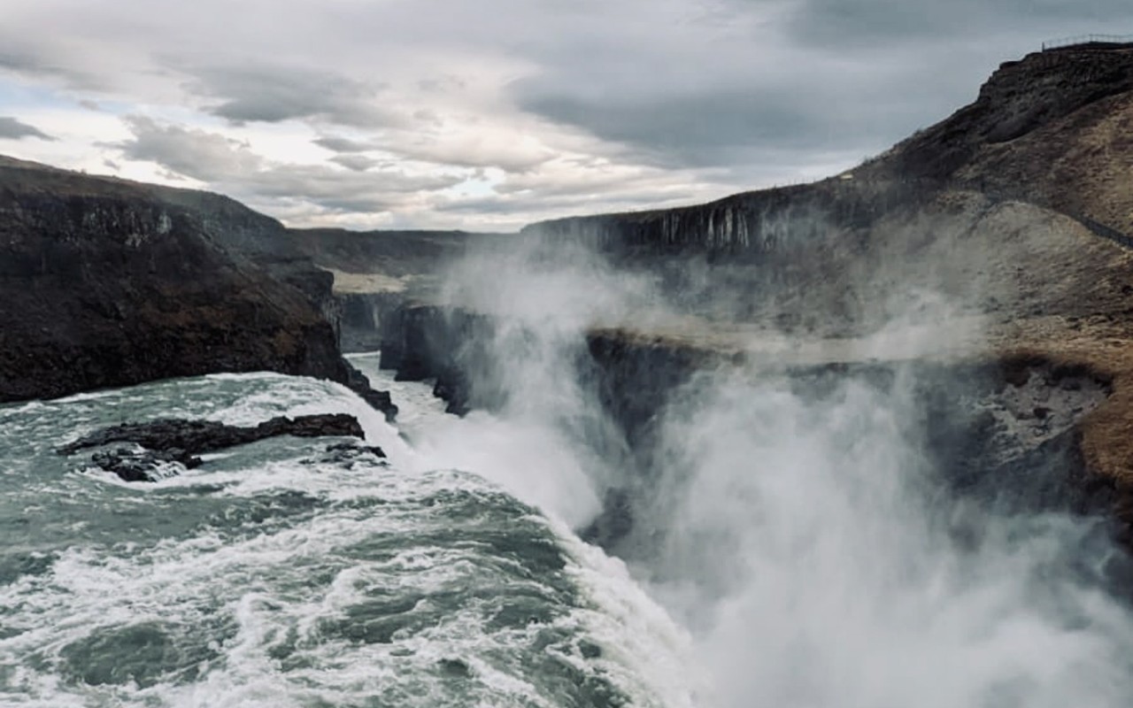 Water Falls on Brown Rocky Mountain