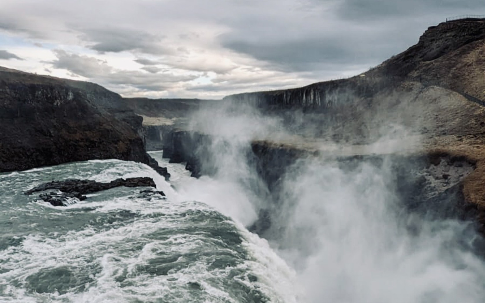 Water Falls on Brown Rocky Mountain