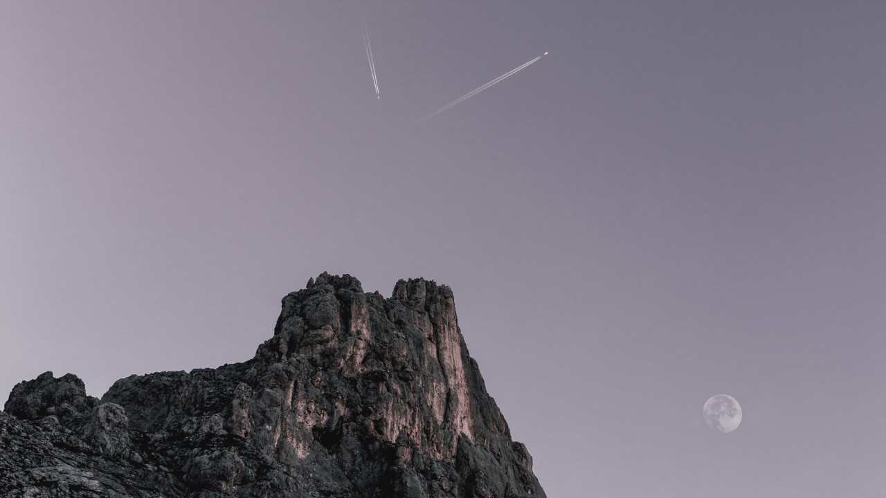 Two Planes Flying over Rock Formation 