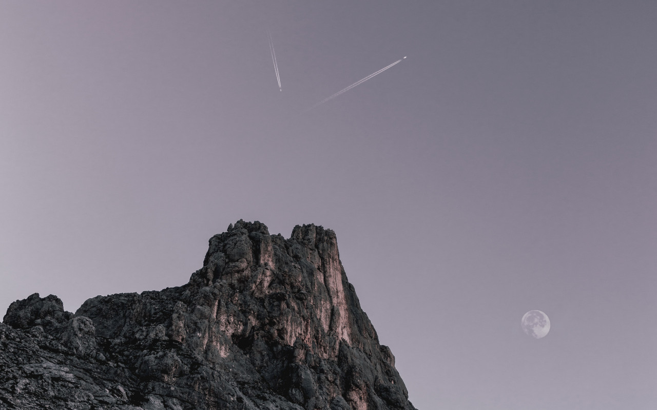Two Planes Flying over Rock Formation 