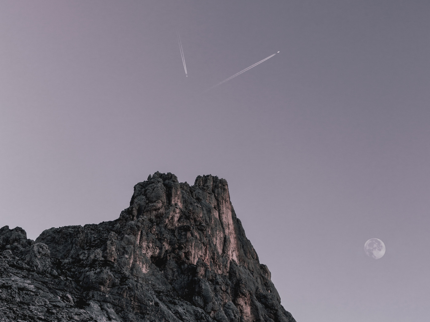 Two Planes Flying over Rock Formation 