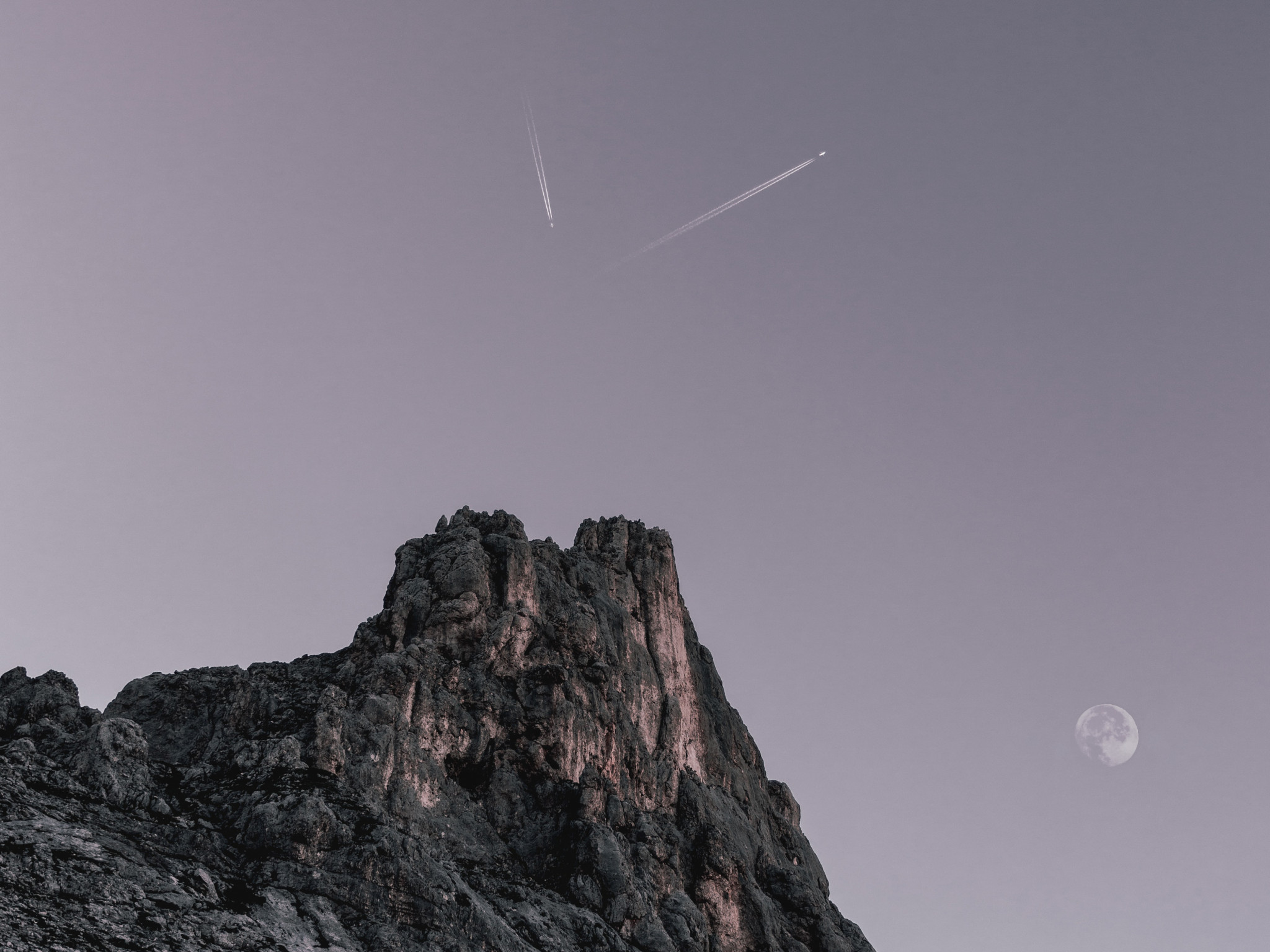 Two Planes Flying over Rock Formation 