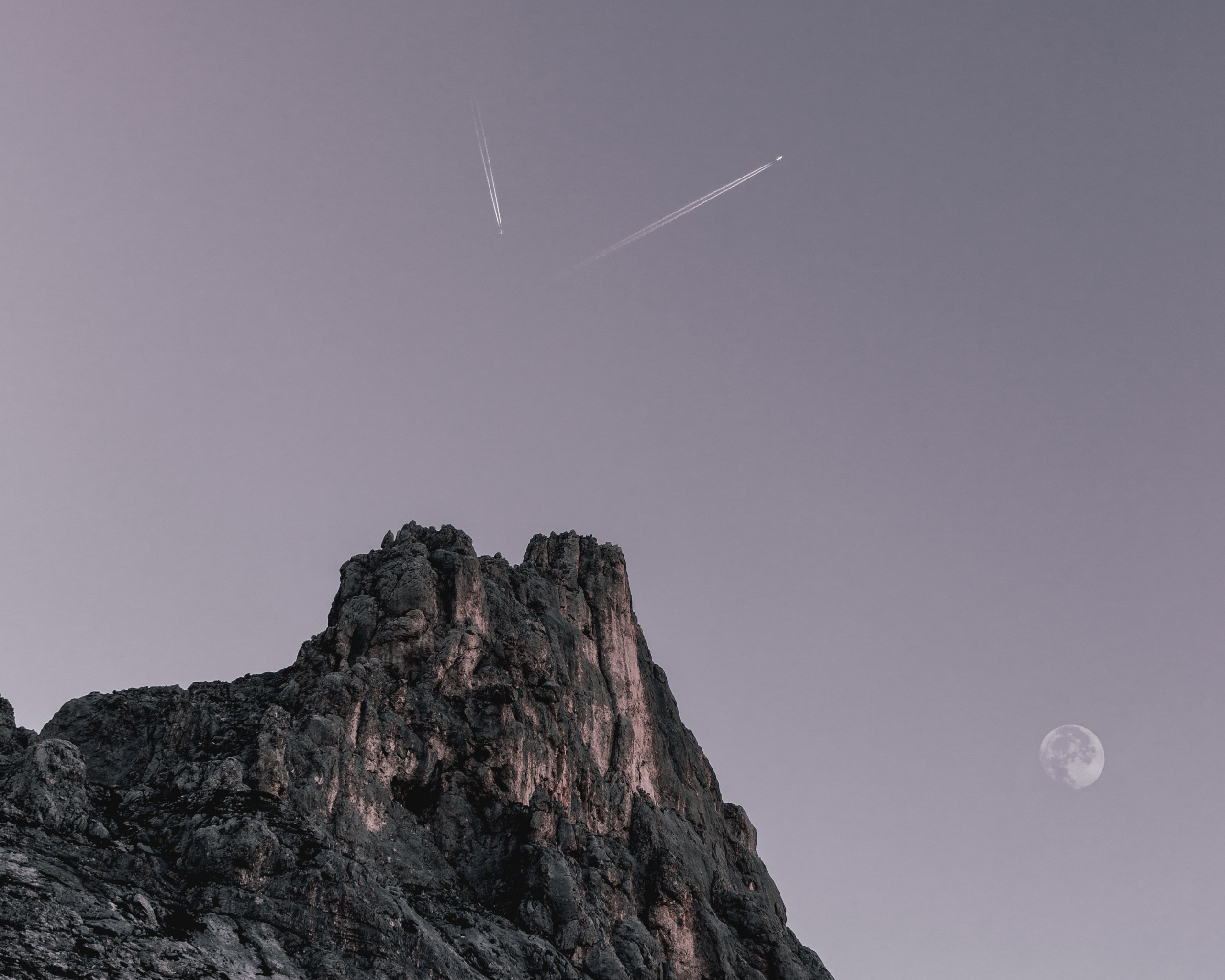 Two Planes Flying over Rock Formation 