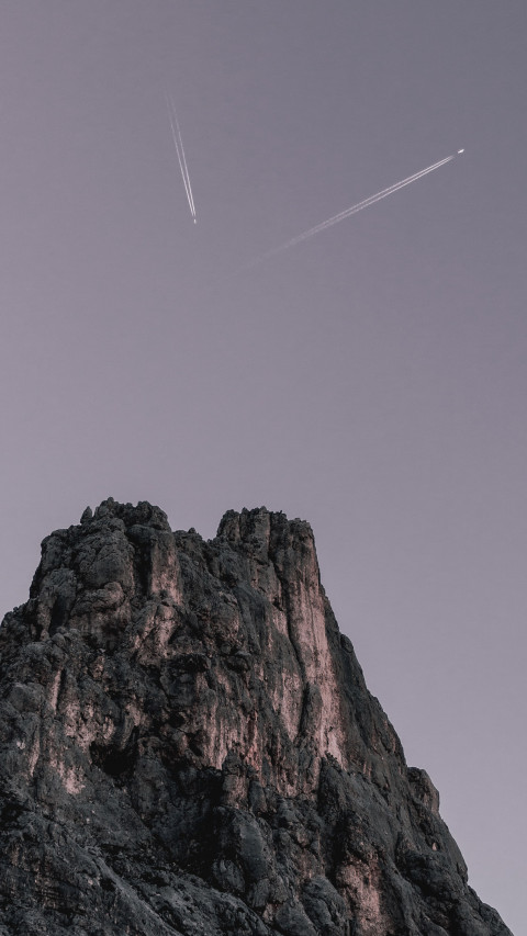 Two Planes Flying over Rock Formation 